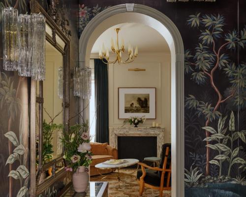 a living room with a mirror and a fireplace at The Bellevue Hotel, in the Unbound Collection by Hyatt in Philadelphia
