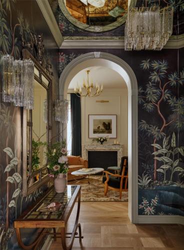 a living room with a large mirror and a fireplace at The Bellevue Hotel, in the Unbound Collection by Hyatt in Philadelphia