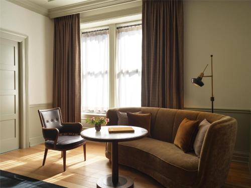 a living room with a couch and a table at The Bellevue Hotel, in the Unbound Collection by Hyatt in Philadelphia
