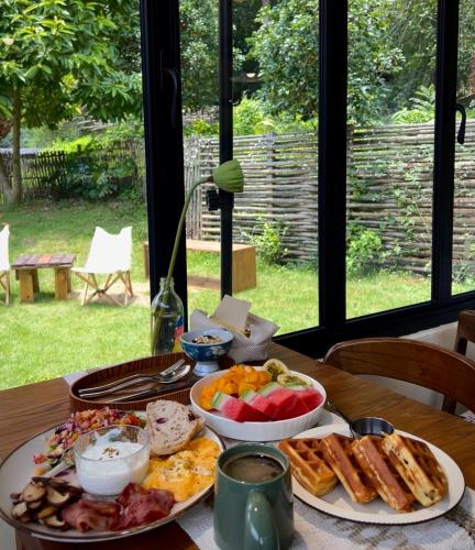 a table with two plates of food on it at Yangshuo Hillside Homestay in Yangshuo
