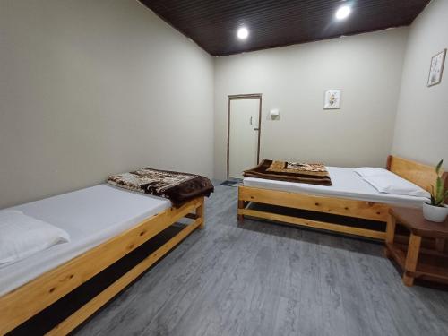 Postel nebo postele na pokoji v ubytování The Rufous Necked Homestay
