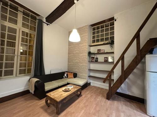 a living room with a couch and a table at Your Little heaven in Bordeaux