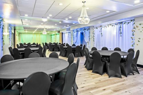 a conference room with tables and chairs and a chandelier at Comfort Inn Largo-Washington DC East in Upper Marlboro