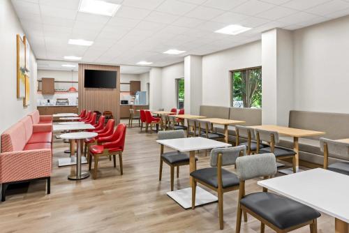 a dining room with tables and red chairs at Comfort Inn Largo-Washington DC East in Upper Marlboro
