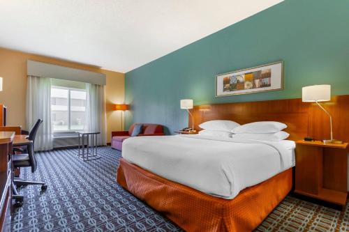 a hotel room with a large bed and a desk at Comfort Inn & Suites Green Bay Stadium Area in Green Bay