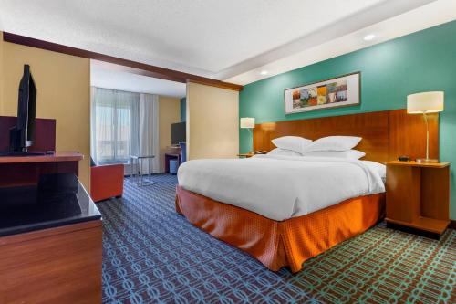 a hotel room with a large bed and a flat screen tv at Comfort Inn & Suites Green Bay Stadium Area in Green Bay