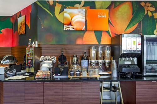 a coffee shop with a counter with a coffee maker at Comfort Inn & Suites Green Bay Stadium Area in Green Bay