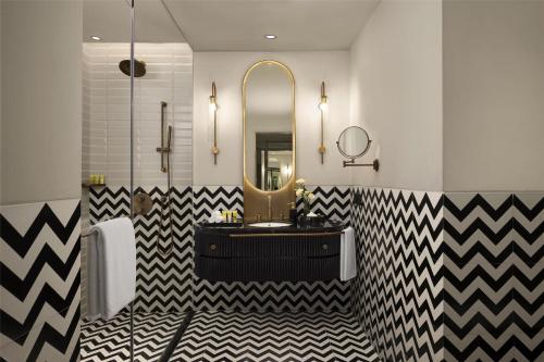 a bathroom with a black and white checkered floor at Hyatt Centric Sector17 Chandigarh in Chandīgarh
