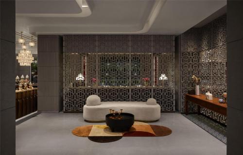 a living room with a white couch and a table at Hyatt Centric Sector17 Chandigarh in Chandīgarh