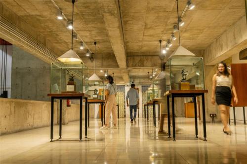 a group of people walking in a room with tables at Hyatt Centric Sector17 Chandigarh in Chandīgarh