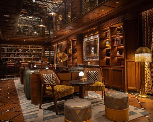 a lobby with chairs and a table and shelves at Hyatt Centric Sector17 Chandigarh in Chandīgarh