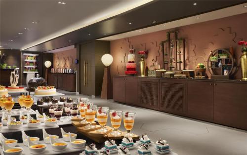 a buffet line with glasses of wine and desserts at Hyatt Centric Sector17 Chandigarh in Chandīgarh