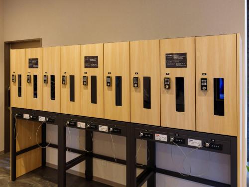 a row of lockers with cell phones on them at Comfort Hotel Mito in Mito