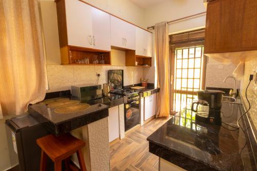 a kitchen with a counter top and a stove at SH Mukudo in Tororo