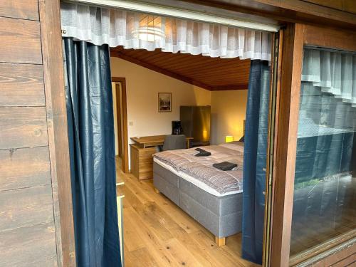 a bedroom with a bed and a desk at Double room near Ritzensee River in Saalfelden am Steinernen Meer