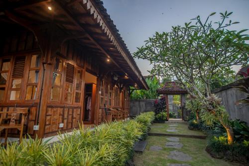 a house with a pathway next to a building at Kerjim Wooden Villa in Ubud
