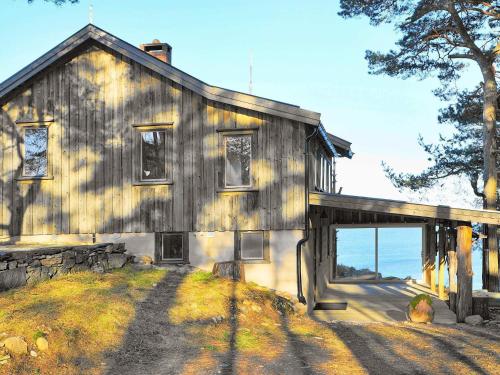 a large wooden house with a large garage at 6 person holiday home in HENÅN in Sundsandvik