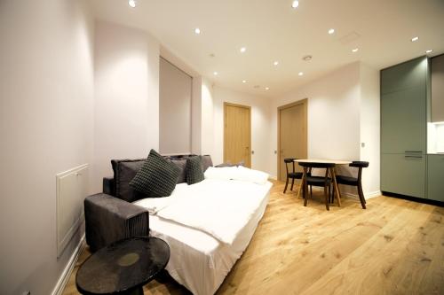 a living room with a bed and a table at Old Town Cozy & Quiet Apartment in Rīga