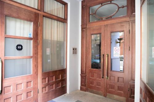 a pair of wooden doors in a hallway at Old Town Cozy & Quiet Apartment in Rīga