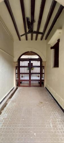 an empty room with a large door in a building at The Imperial Regency in Porbandar