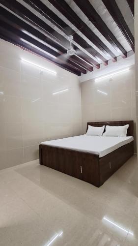 a bedroom with a large bed in a room at The Imperial Regency in Porbandar