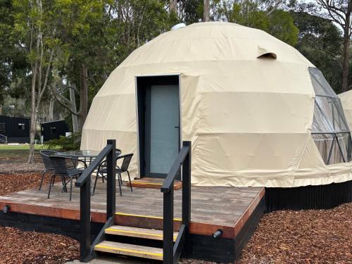 a yurt with a table and a table and chairs at BIG4 Yarra Valley Park Lane Holiday Park in Healesville