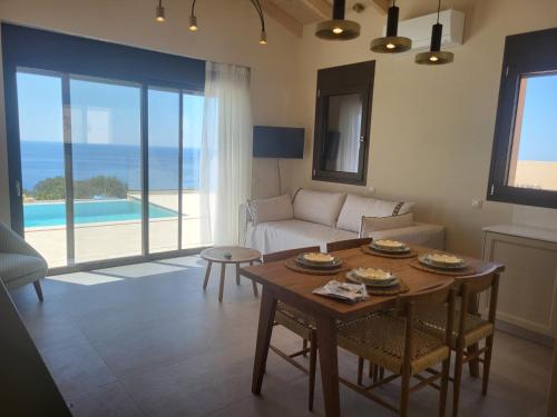 a living room with a couch and a table at villas cape in Plateies