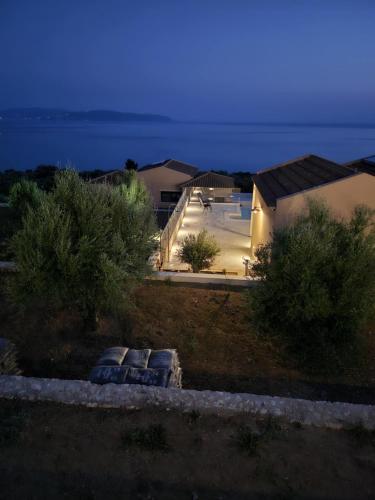 a view of a house with three pillows in a yard at villas cape in Plateies