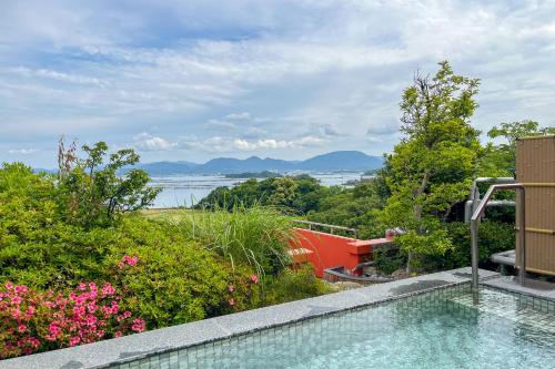 a swimming pool with a view of the water at Hotel Sunresort Shirahama in Shirahama
