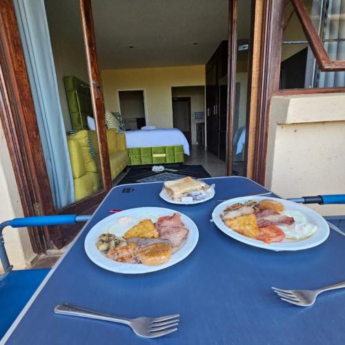 two plates of food on a blue table at Ocean View Villas F3 in Port Edward