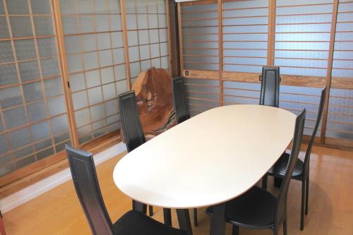 a white table and chairs in a room at Vacation House near Amanohashidate opened in 2025 in Miyazu