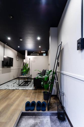 a living room with a black ceiling at おやど紀伊国屋大黒町通 in Nagasaki