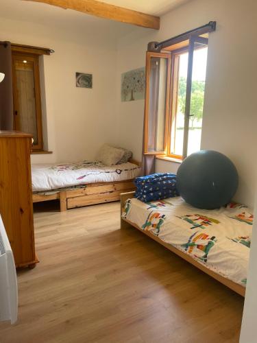 a bedroom with two beds and a window at Maisonnette de campagne 70m2 in Lartigue