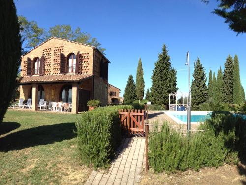 an external view of a house and a swimming pool at Montaione Oasis Shared Villa in Montaione