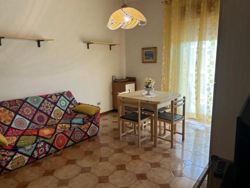 a living room with a couch and a table at Holiday residence Sole San Marco in Calatabiano