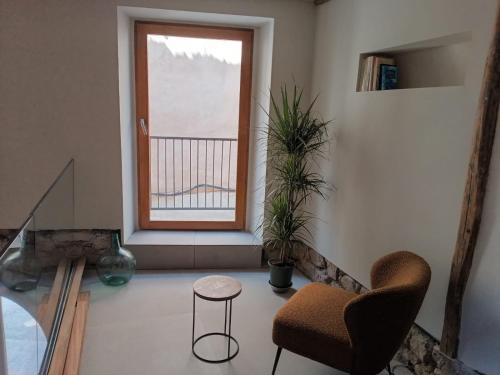 a living room with a chair and a window at Patio y Calados Rioja Suites in Cenicero