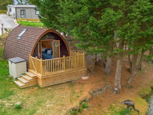 a gazebo with a deck and a house at Lakeside Haven -Fishing Lakes, Heated Outdoor Swimming Pool 500yrds on Sister Park , Pool Open May to September in Cheriton Bishop