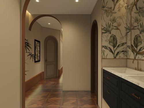 a bathroom with a sink and a hallway at Nehal Hotel in Abu Dhabi