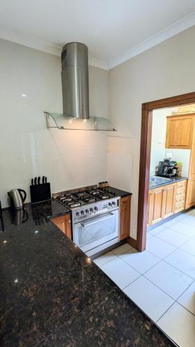 a kitchen with a stove and a counter top at Shangri-La! Secluded & Lush Country Property in Kin Kin