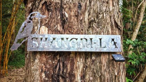 a sign on the side of a tree at Shangri-La! Secluded & Lush Country Property in Kin Kin