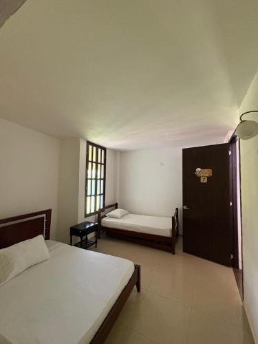 Cama o camas de una habitación en Hotel Jardin Cafetero Quindio