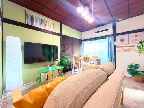a living room with a couch and a flat screen tv at Nakakasai Kodate NKK21 in Tokyo