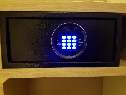 a small television with a blue clock on it at Bold Hotel Jakarta in Jakarta