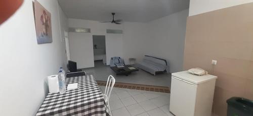 a room with a room with a table and a bed at Ξενώνας OLEAVIA in Kalamata