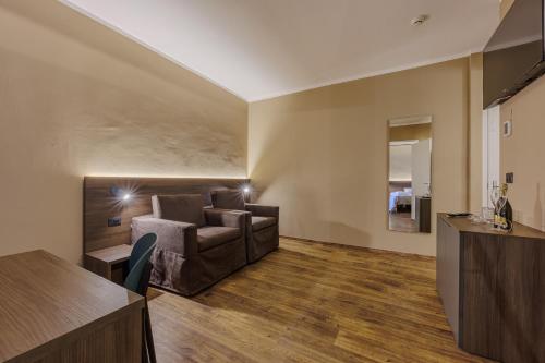 a living room with a couch and a table at Hotel San Marco in Bardolino