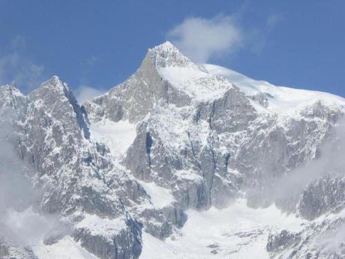 a mountain covered in snow with a blue sky at Family Stay in Aletsch Alps in Bellwald