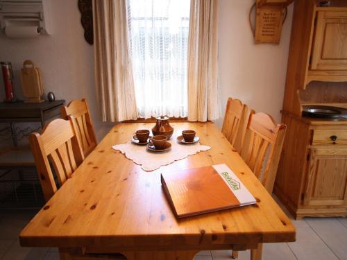 a wooden table in a kitchen with a book on it at Family Stay in Aletsch Alps in Bellwald