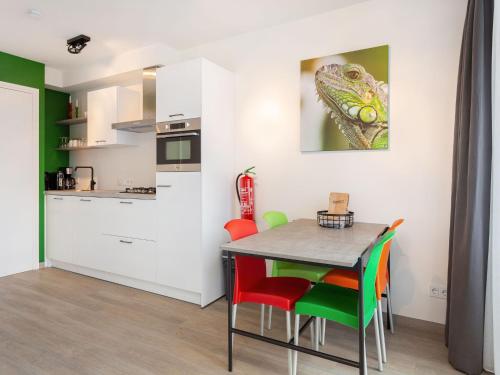 a kitchen and dining room with a table and chairs at Apartment located directly on the Sneekermeer in Offingawier