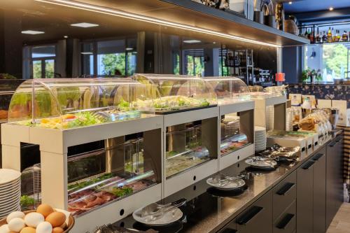 a buffet line with food in glass containers at Hotel San Marco in Bardolino
