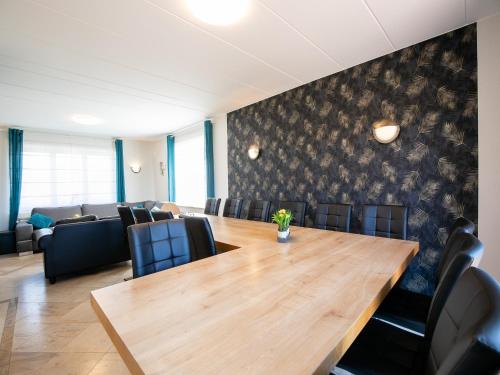 a conference room with a wooden table and chairs at Villa East Canton with Sauna in Nieder-Emmels